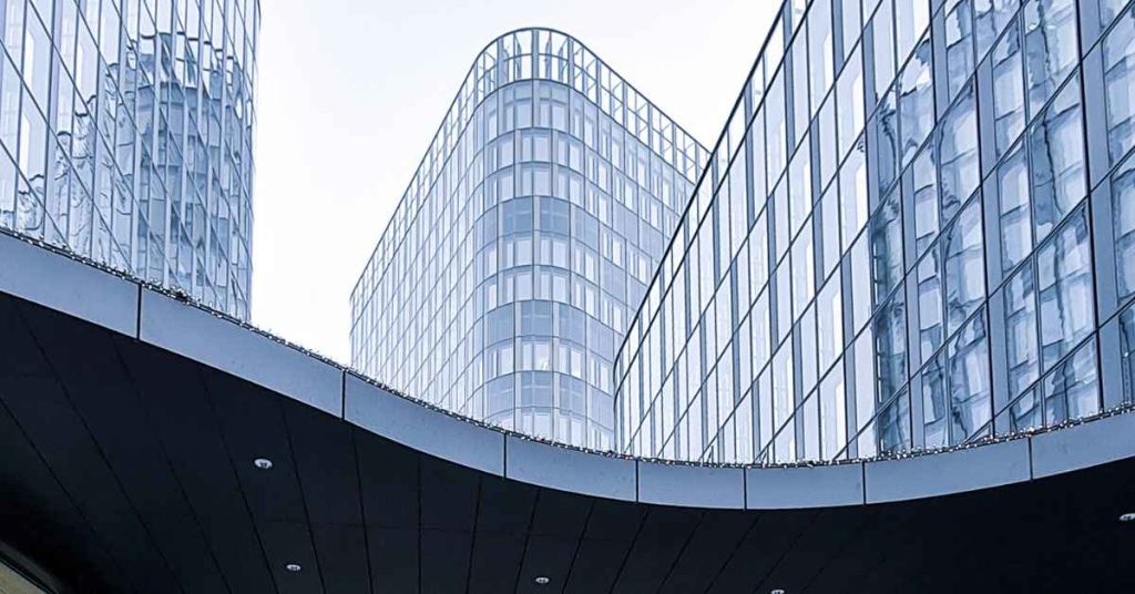 Three glass buildings in a city